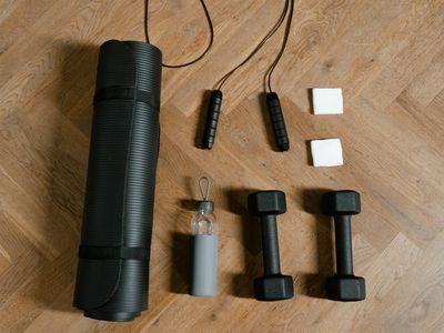Minimalist jump rope and water bottle on a mat